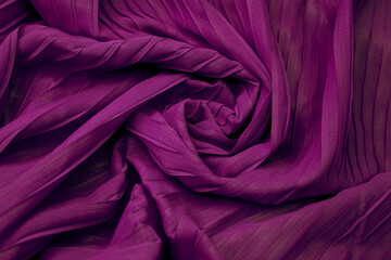 Purple fabric with delicate folds creating an abstract background