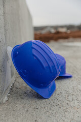 there is a hard hat on the ground by the wall