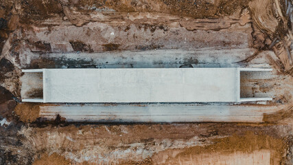 a water trough that is on a wooden stand in dirt