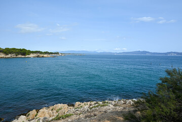 Scenic coastal landscape with a green shoreline and blue waters. Costa Brava, Spain