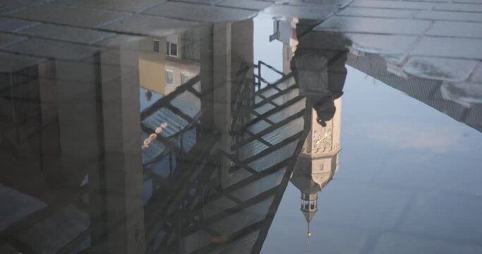 Slow-motion of reflection of the city church of St. Michael in a puddle in the center of Jena