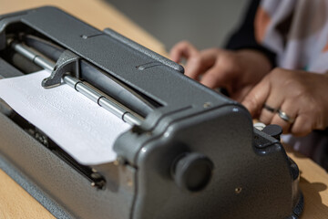 Blind person with a braille machine, Disability concept