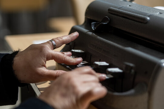 Blind person with a braille machine, Disability concept