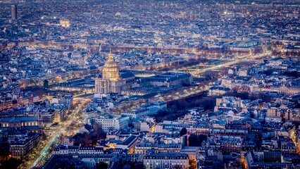 Aerial view of a bustling city skyline at night with numerous illuminated buildings, Paris, France