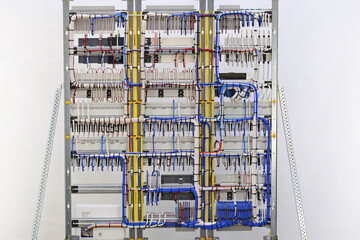 Connection of electrical wires to electronic control modules in an electrical distribution cabinet.