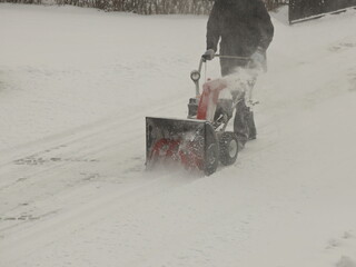 Robotnik clears snow from the sidewalk with a manual snowplow driven by a gasoline engine. Fighting...
