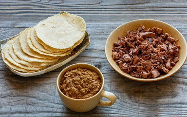Tortillas made with nixtamalized white corn flour, Veracruz-style thick sauce pipian tlatonile, and shredded and roasted jackfruit. Vegan Mexican-style meal.