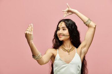 indian woman in white dress posing with hands up.