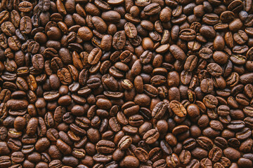 Close up of dark roasted coffee beans filling the frame can be use as background. 