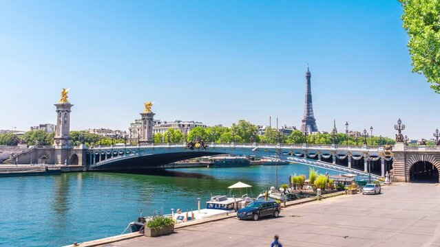 A timelapse of the Eiffel Tower along the river Seine with flyboats passing by with motion blur.Sunny but cloudy spring summer day paris city famous riverside bay tower view bridge timelapse panorama