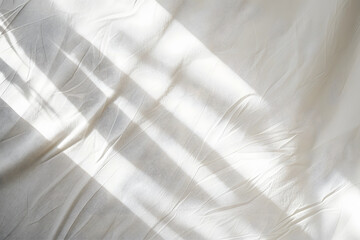 Sunbeams cast dramatic geometric shadows across the walls and floor of an empty minimalist interior space. Background for product mockup.