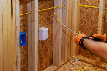 Wires are connected to socket boxes during construction of new building by an electrician