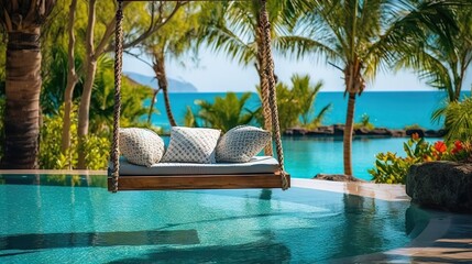 Obraz premium A serene setting with a poolside swing bed overlooking the tranquil ocean bordered by palm trees and clear skies