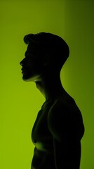 male silhouette against a vibrant green background with dramatic lighting