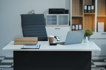 workspace area with laptop tablet smartphone and paperwork on the table in the office concept.