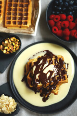 Dutch waffles with vanilla sauce, chocolate and berries.