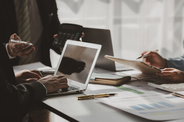 team of marketing is meeting about company finance, an employee is using calculator to calculate...