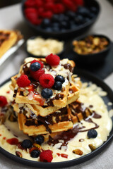 Dutch waffles with vanilla sauce, chocolate and berries.