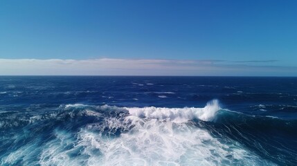 Vast ocean waves under clear blue sky