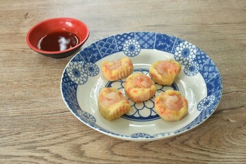 steamed chicken tendon with mashed pork topping shrimp or dim sum on plate dipping sour soy sauce  