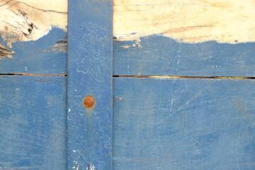 stacked blue yellow wooden planks, nailed. sengon wood. This image is suitable for use as a background or wallpaper.. old wooden door. 