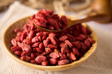 Dried goji berries on bowls and spoon, fruit from china and tibet