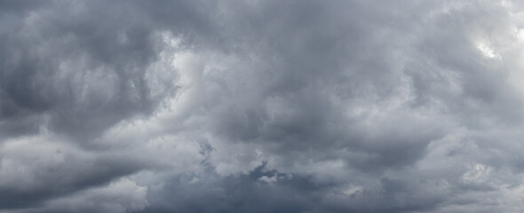 A stormy sky with thick gray clouds before a thunderstorm