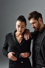 A loving couple in elegant attire, standing side by side.