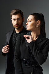 A loving couple in elegant attire standing together.