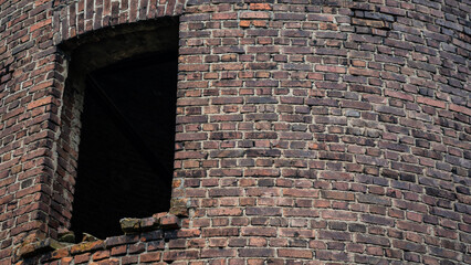 A single window of an old brick tower