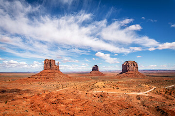 Monument Valley's classic view of they East and West Mittens and Merricks Butte  during a bright,...