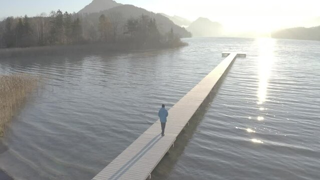 Aerial View of Hiker on Pier at Sunset in Autumn, Fuschlsee, Salzburg, Austria, D-Log