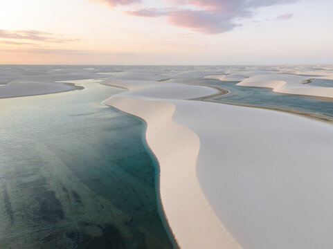 Aerial view of minimalist Lencois Maranhenses National Park desert with lagoon, Barreirinhas, Maranhao, Brazil.