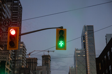 Evening cityscape - red stop lights - skyscrapers and construction crane against dusk sky. Taken in...