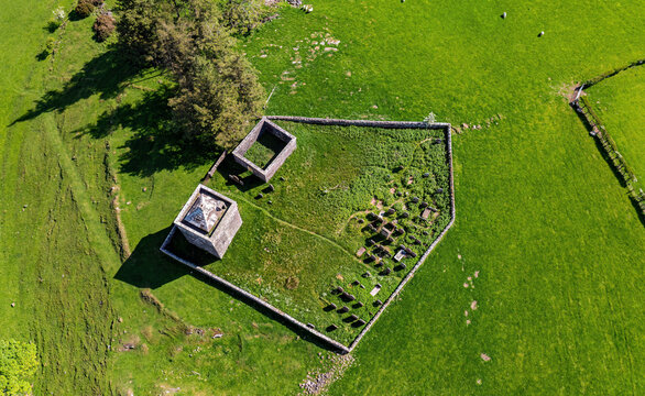 Aerial view of Tower of Repentance in high grass meadow, Lockerbie, Scotland, United Kingdom.