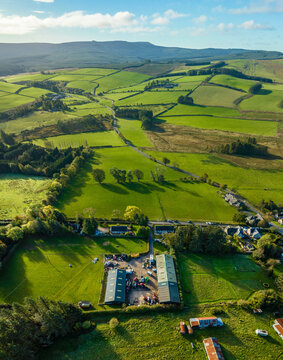 Aerial view of beautiful countryside with river, meadow, and trees, Chesters, Hawick, Scotland, United Kingdom.