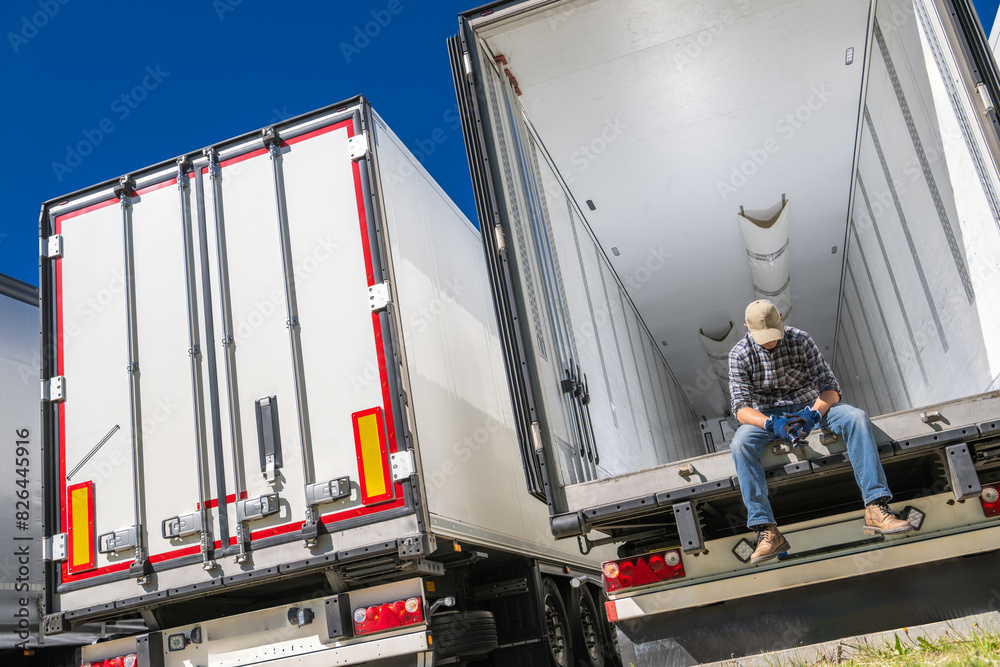 Poster Devastated Trucker Sitting on Semi Truck Trailer Bed