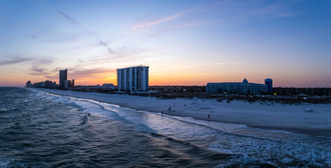 Aerial view of beautiful beach town with sandy coastline and blue ocean, Orange Beach, Gulf of Mexico, United States.