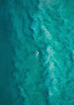 Aerial view of surfer at Tallow Beach, Byron Bay, New South Wales, Australia.