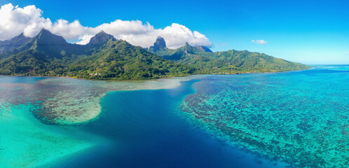 Aerial view of sandy beach and turquoise lagoon in Ha'apiti, Moorea Reef, Papeete, French Polynesia.