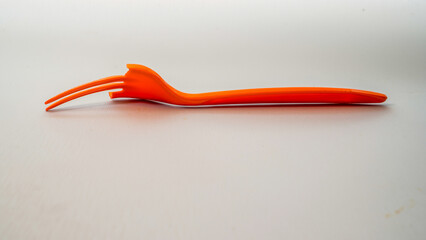 close up view of a broken orange fork isolated on white with empty space background. 