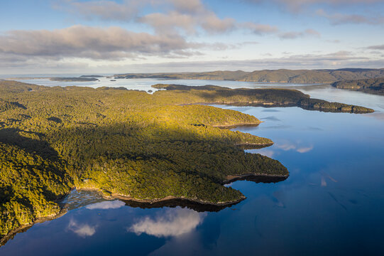 Aerial view of beautiful coastal landscape with mountain peaks and sea, North Arm hut, Dynamit point, Stewart Island, New Zealand.