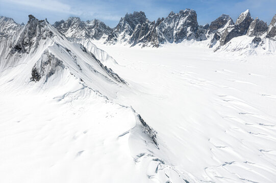 Aerial view of snow-covered landscape with Lukpe La Pass and Solu Tower, Gilgit-Baltistan, Pakistan.