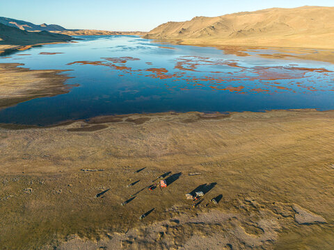 Aerial view of Baga Lake with mountain peaks and valley, Tsetsen-Uul, Zavkhan, Mongolia.