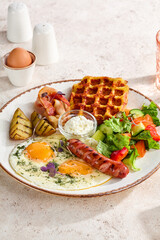 Hearty Combo Breakfast with Sunny Side Up Eggs, Waffle, Sausage, Bacon, and Vegetable Salad