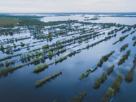 Aerial view of flooded wetland with floating houses and boats, Scheendijk, The Netherlands.