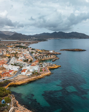 Aerial view of beautiful coastal bay at Cala Tabaco, Isla Plana, Murcia, Spain.