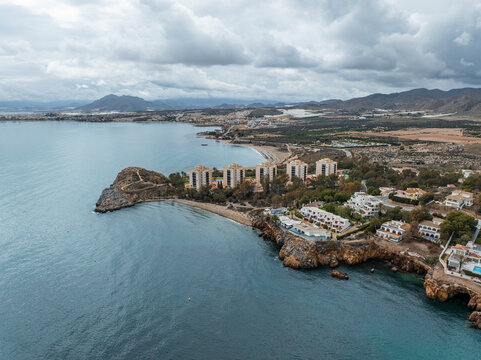 Aerial view of coastal cliff and seaside of Isla Plana, Cartagena, Murcia, Spain, hotel.