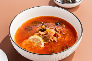 Hearty Meat Solyanka Soup with Olives and Lemon. Traditional Russian Cuisine
