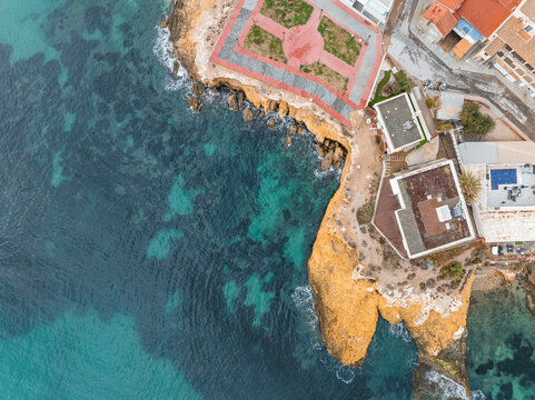 Aerial view of beautiful coastal tower at sunset, Isla Plana, Cartagena, Spain.